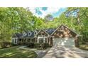 Charming brick home featuring bay windows, an attached garage and mature trees at 4703 Waverly Walk, Douglasville, GA 30135