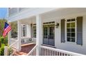Inviting front porch featuring brick flooring, porch swing, and classic architectural details at 210 Tifton Ln, Roswell, GA 30075