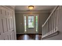 Bright foyer with hardwood floors, complemented by a staircase and a view of the front door at 3104 Leyland Ct, Decatur, GA 30034