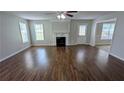 Spacious living room with hardwood floors, a fireplace, and natural light streaming through the windows at 3104 Leyland Ct, Decatur, GA 30034
