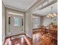 Elegant entryway with hardwood floors, decorative glass door, and adjacent dining room at 313 Red Fox Dr, Canton, GA 30114