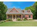Beautiful two-story home with well-manicured lawn, stone accents, and a welcoming entrance at 313 Red Fox Dr, Canton, GA 30114