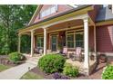 Charming front porch with rocking chairs and manicured landscaping for relaxing and curb appeal at 313 Red Fox Dr, Canton, GA 30114