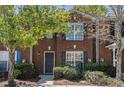 Lovely brick townhome showcasing well-maintained landscaping, large window, and dark shutters at 3149 Kingswood Gln, Decatur, GA 30034
