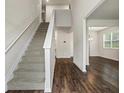 Bright entryway featuring hardwood floors, staircase, and an open floor plan at 3573 Stonebranch Ln, Loganville, GA 30052