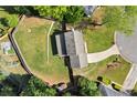 Aerial view of a property with a spacious, well-maintained yard, privacy fence, and mature trees at 660 Cranberry Ct, Roswell, GA 30076