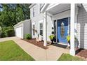 Inviting front entrance with blue door, manicured landscaping, and attached garage enhancing curb appeal at 660 Cranberry Ct, Roswell, GA 30076