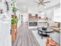 Cozy living room with hardwood floors, modern lighting, and a stunning fireplace feature at 11 Poplar St, Porterdale, GA 30014