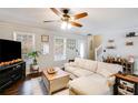 Bright living room with lots of windows, neutral paint, ceiling fan, and hardwood floors at 115 N Loblolly Xing, Temple, GA 30179