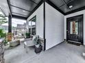 Inviting front porch with comfortable seating, stone accents, and stylish décor at 132 Neese Farm Dr, Woodstock, GA 30188