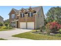 Charming two-story home with a brick facade, attached garage, and landscaped front yard at 23 Dynasty Dr, Fairburn, GA 30213