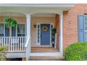 Inviting front entrance with a blue door, decorative wreath, and a cozy porch at 1099 Mount Water Ln, Lawrenceville, GA 30043