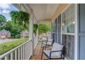 Relaxing front porch with comfortable seating, hanging plants, and a view of the neighborhood at 1099 Mount Water Ln, Lawrenceville, GA 30043