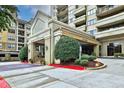 Inviting building entrance with covered parking, mature landscaping, and an easy path to the front doors at 795 Hammond Dr # 808, Atlanta, GA 30328