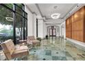 Well-appointed lobby with plush seating, stylish lighting, and expansive windows offering serene outdoor views at 795 Hammond Dr # 808, Atlanta, GA 30328