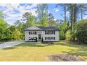 Inviting two-story home boasts a lush green lawn and a timeless painted brick exterior at 2120 Pair Sw Rd, Marietta, GA 30008