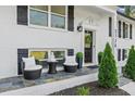 Charming front porch with elegant seating, manicured shrubs, and a welcoming front door at 2120 Pair Sw Rd, Marietta, GA 30008