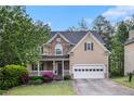 Attractive two-story home with stone accents, a welcoming front porch, and an attached two-car garage at 2164 Caneridge Sw Dr, Marietta, GA 30064