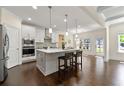 Bright kitchen features a center island, stainless steel appliances, and hardwood floors at 3051 Mountain Shadow Way, Marietta, GA 30064