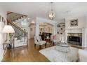 Bright living room features hardwood floors, a fireplace, and an elegant staircase at 735 Neel Reid Dr, Roswell, GA 30075