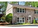 Charming brick townhouse with inviting curb appeal and mature landscaping at 2495 Northlake Ne Ct, Atlanta, GA 30345