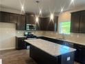 Modern kitchen with stainless steel appliances, granite countertops, and a large island at 4120 Chapel Hill Reserve, Douglasville, GA 30135
