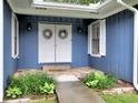Inviting front porch with double doors, decorative wreaths, and stone pathway leading to the entrance at 4579 Amberly S Ct, Atlanta, GA 30360