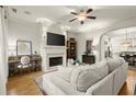 Bright living room with hardwood floors, fireplace, modern furniture, and abundant natural light at 719 Hammond Dr, Woodstock, GA 30188