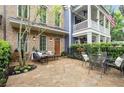 Charming patio area with stone tile and a fenced garden offers an outdoor dining space at 719 Hammond Dr, Woodstock, GA 30188