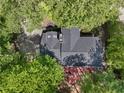 Aerial view of a home with a gray roof surrounded by mature trees and lush landscaping at 1819 Walker Ridge Sw Dr, Marietta, GA 30064