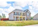 Well-maintained home with brick and stone facade, green lawn, and mature landscaping at 206 Prescott St, Locust Grove, GA 30248