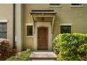 Exterior shot of the front entrance of townhome with a covered entryway and a wooden front door at 217 Knob Hills Cir, Decatur, GA 30030