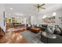 Open concept living room, dining area and kitchen featuring hardwood floors and comfortable seating at 217 Knob Hills Cir, Decatur, GA 30030