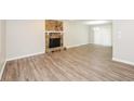 Bright living room featuring a stone fireplace, neutral walls, and wood-look flooring at 4391 Sandy Plains Rd, Marietta, GA 30066