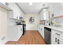 Modern kitchen featuring white cabinets, quartz countertops, and stainless steel appliances at 247 Mandy Ct, Mcdonough, GA 30252