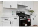 Close up on gas range and quartz countertop in modern, updated kitchen at 247 Mandy Ct, Mcdonough, GA 30252