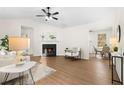 Bright living room featuring a fireplace, hardwood floors, and neutral decor at 247 Mandy Ct, Mcdonough, GA 30252