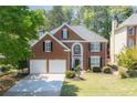 Charming two-story brick home with a well-manicured lawn and a classic front door at 4044 Kenway Se Pl, Smyrna, GA 30082