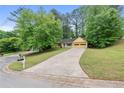 Spacious home on a large lot featuring a long drive way and mature trees at 502 Knollwood Pl, Woodstock, GA 30188