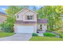 Charming two-story home with a well-manicured lawn, attached garage, and inviting front porch at 986 Franklin Ridge Ct, Sugar Hill, GA 30518