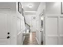 Bright hallway with white trim, modern decor, and access to a well-lit bathroom at 1156 Cotton Gin Ct, Lawrenceville, GA 30045