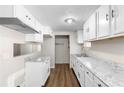 Bright kitchen featuring new white cabinets, granite countertops, and updated appliances at 60 Highland Dr, Stockbridge, GA 30281