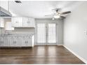 Open kitchen and dining area with stylish cabinets, countertops, ceiling fan, and a backyard view at 60 Highland Dr, Stockbridge, GA 30281