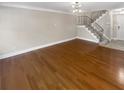 Open floor plan features hardwood floors and neutral color palette; staircase in background at 6980 Roswell Rd # J6, Atlanta, GA 30328
