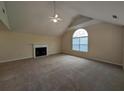 Spacious living room with a fireplace, large window, and neutral carpeting at 3413 Creekview Dr, Rex, GA 30273