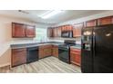 Well-lit kitchen featuring granite countertops, dark appliances, wood cabinets, and ample counter space at 4205 Post Oak Grv, Atlanta, GA 30349