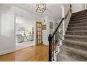 Inviting foyer with hardwood floors, staircase with decorative iron railing, and views into the living area at 546 Wagon Wheel Climb, Lawrenceville, GA 30044