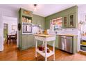 Charming kitchen features custom cabinetry, stainless steel appliances, and hardwood floors at 546 Wagon Wheel Climb, Lawrenceville, GA 30044