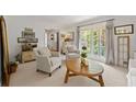 Bright living room featuring large windows, neutral carpet, and stylish decor at 546 Wagon Wheel Climb, Lawrenceville, GA 30044