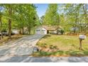Well-maintained home with a spacious front yard, two-car garage and ample driveway space at 6095 Wayfarer Dr, Villa Rica, GA 30180